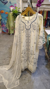 Off-White embroidered lawn suit with three-piece set, featuring detailed embroidery and traditional design elements.