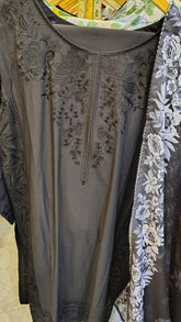 Elegant black embroidered lawn 3-piece suit with intricate embroidery, displayed on a hanger, showcasing traditional fashion style.