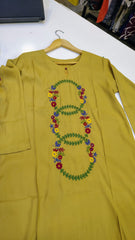 Embroidered mustard lawn kurta from Fashion Street with intricate floral designs and traditional embroidery, displayed on a hanger.