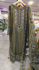 Olive green 3-piece embroidered lawn suit from Fashion Street with intricate embroidery on the fabric, displayed on a flat surface.