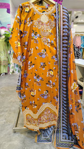 Mustard floral 3-piece lawn suit by Fashion Street, featuring a printed top, matching trousers, and dupatta laid out flat.