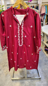 Maroon embroidered 2-piece lawn suit with intricate designs, stylish traditional attire by Fashion Street, displayed on a hanger.