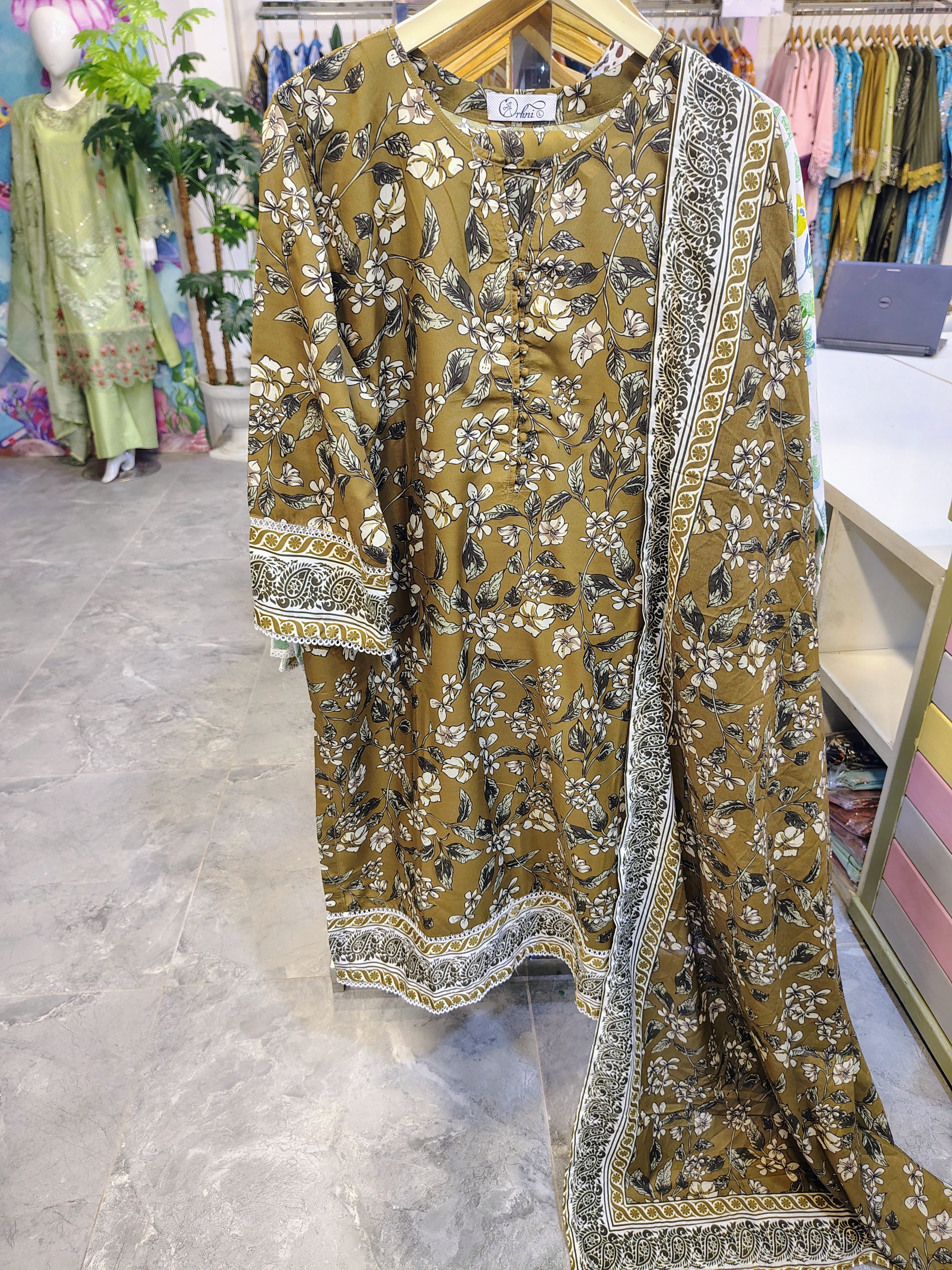 Brown printed 3-piece lawn suit by Fashion Street featuring intricate patterns, lightweight fabric, and traditional design details.