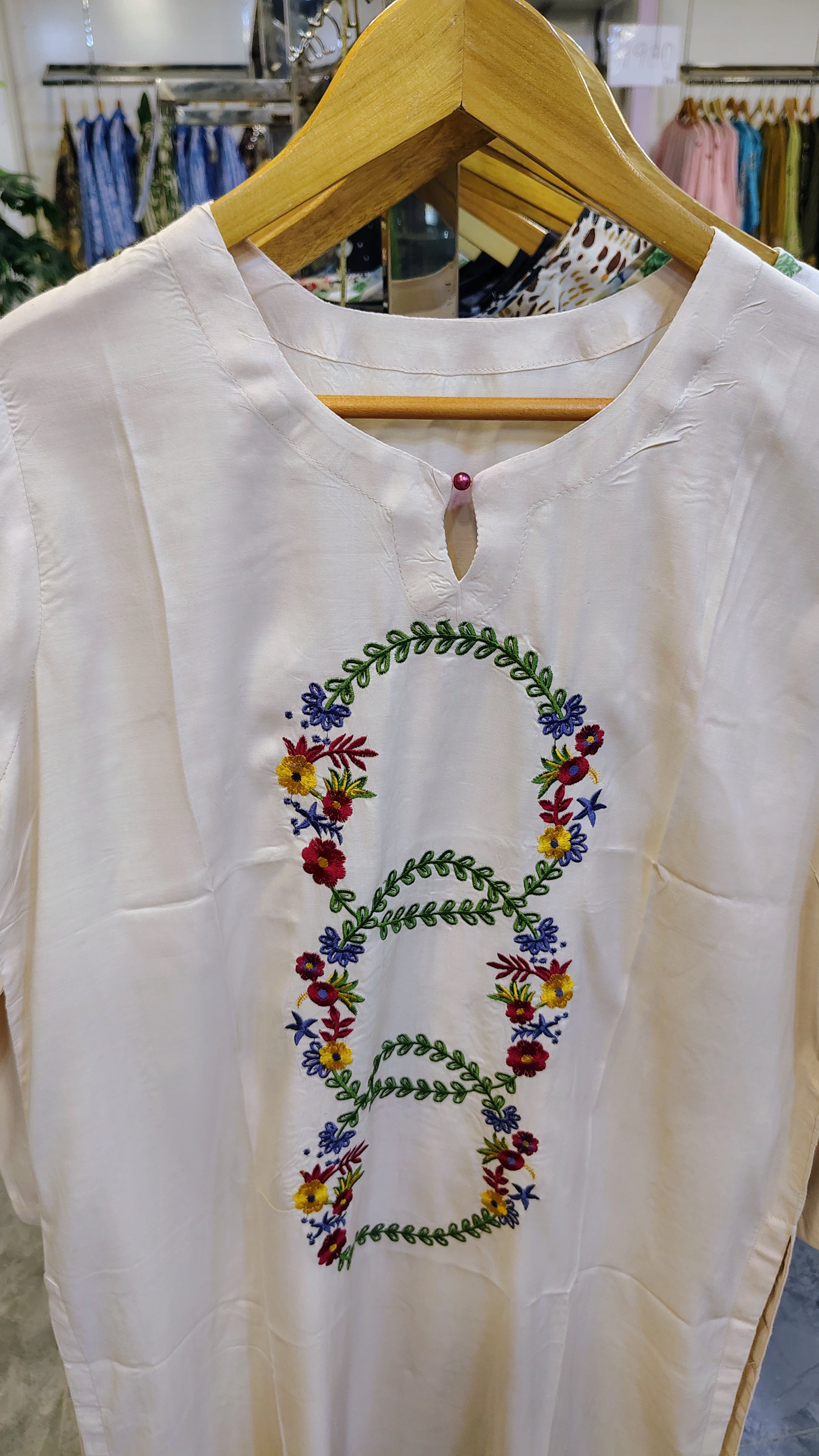 Off-White long embroidered lawn kurta with intricate embroidery, stylish neckline, and traditional design suitable for festive wear.