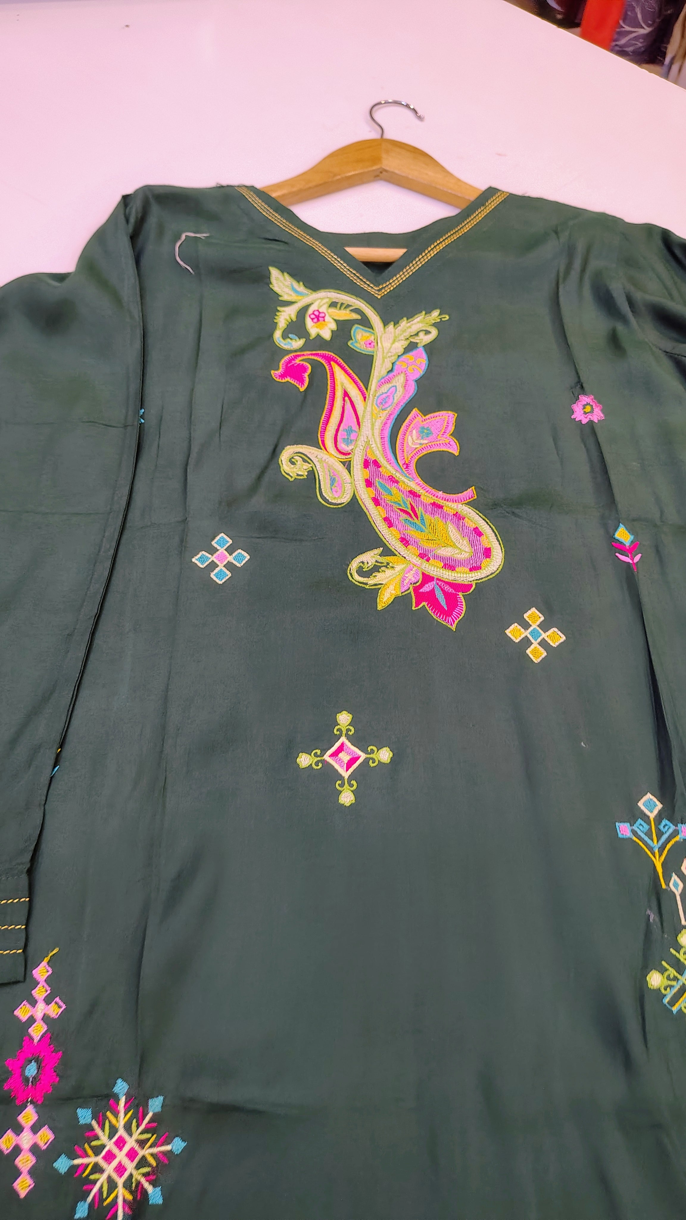 Elegant green embroidered lawn kurta with intricate detailing, showcasing a stylish and traditional fashion piece.